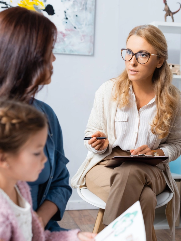 Female counselor with woman and child
