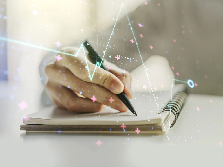 Closeup of a hand writing on a notebook
