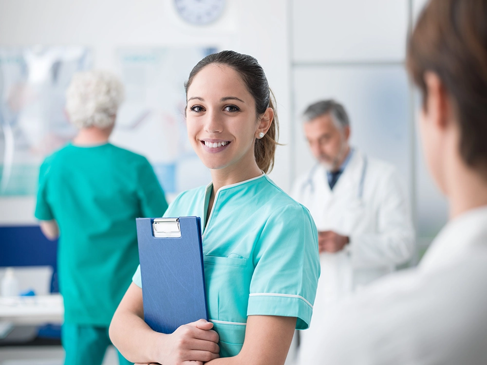 shutterstock_1029028150-scaled-2026 Female student in scrubs holding a clipboard